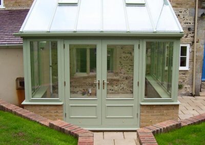 A green conservatory made of timber
