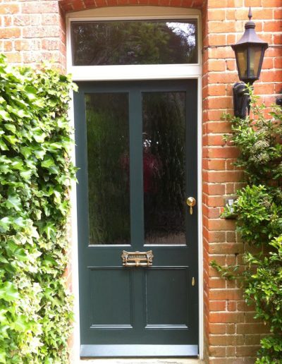 green front door with large windows