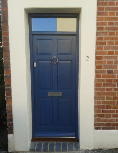 blue timber door with knocker