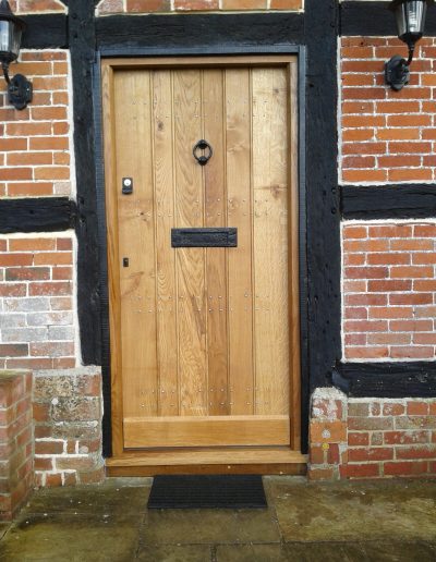 beautiful studded timber door with knocker